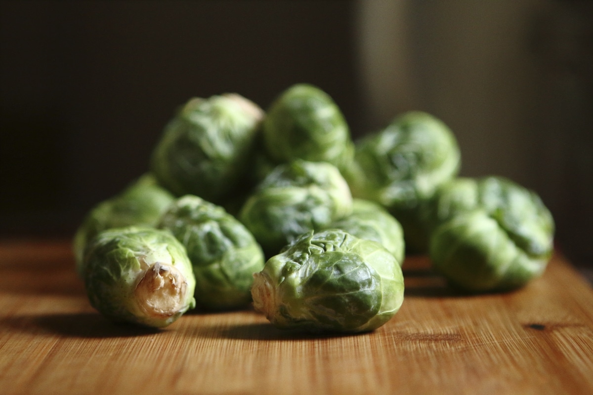 brussel sprouts on wooden cutting board