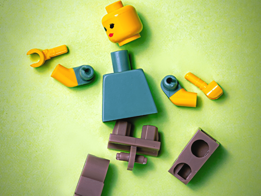 overwhelmed broken legos on green background