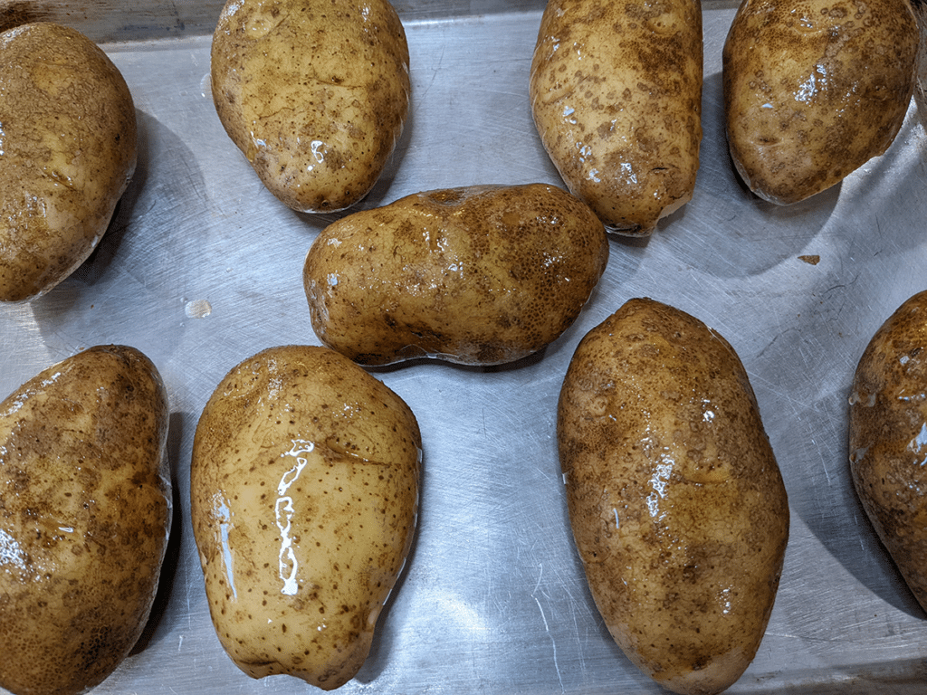 Baked potatoes brushed with olive oil 